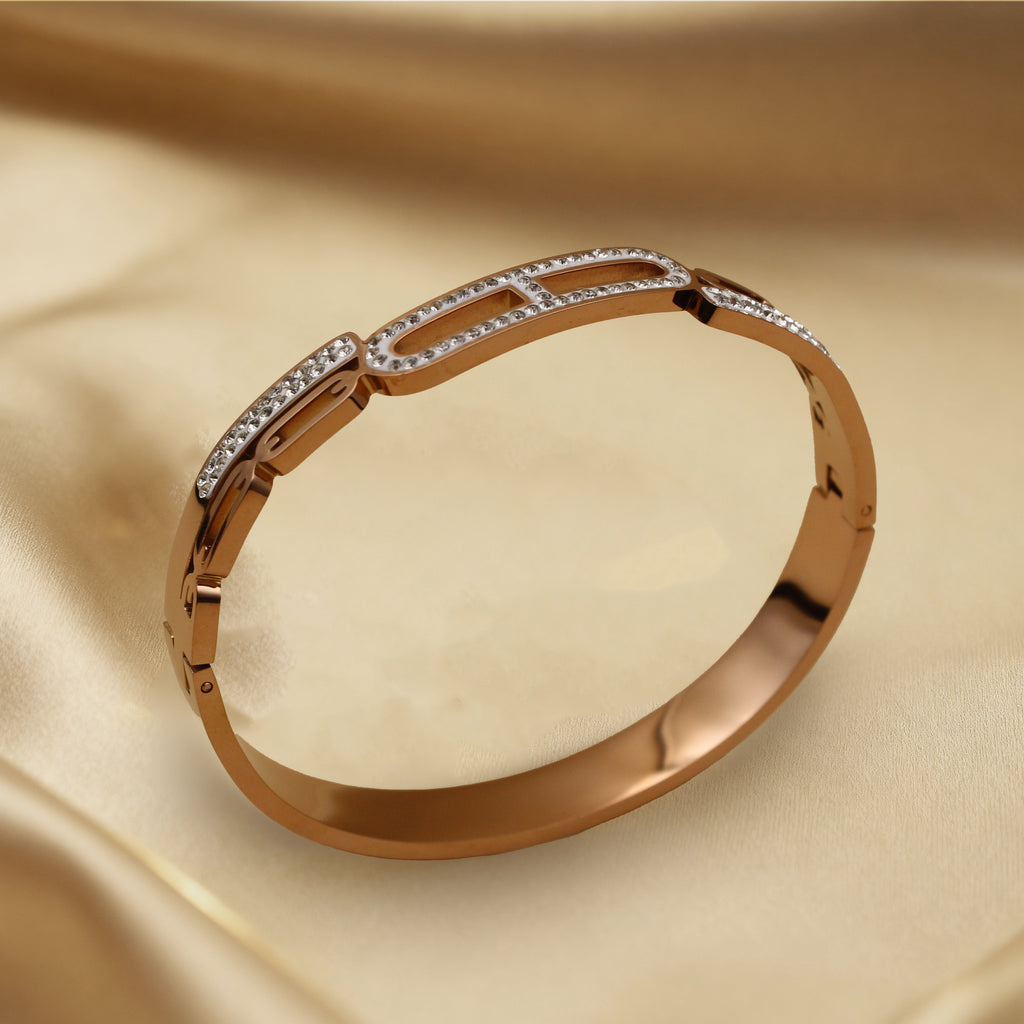 Contemporary Gold Tone Bangle with Linked Crystal Pattern