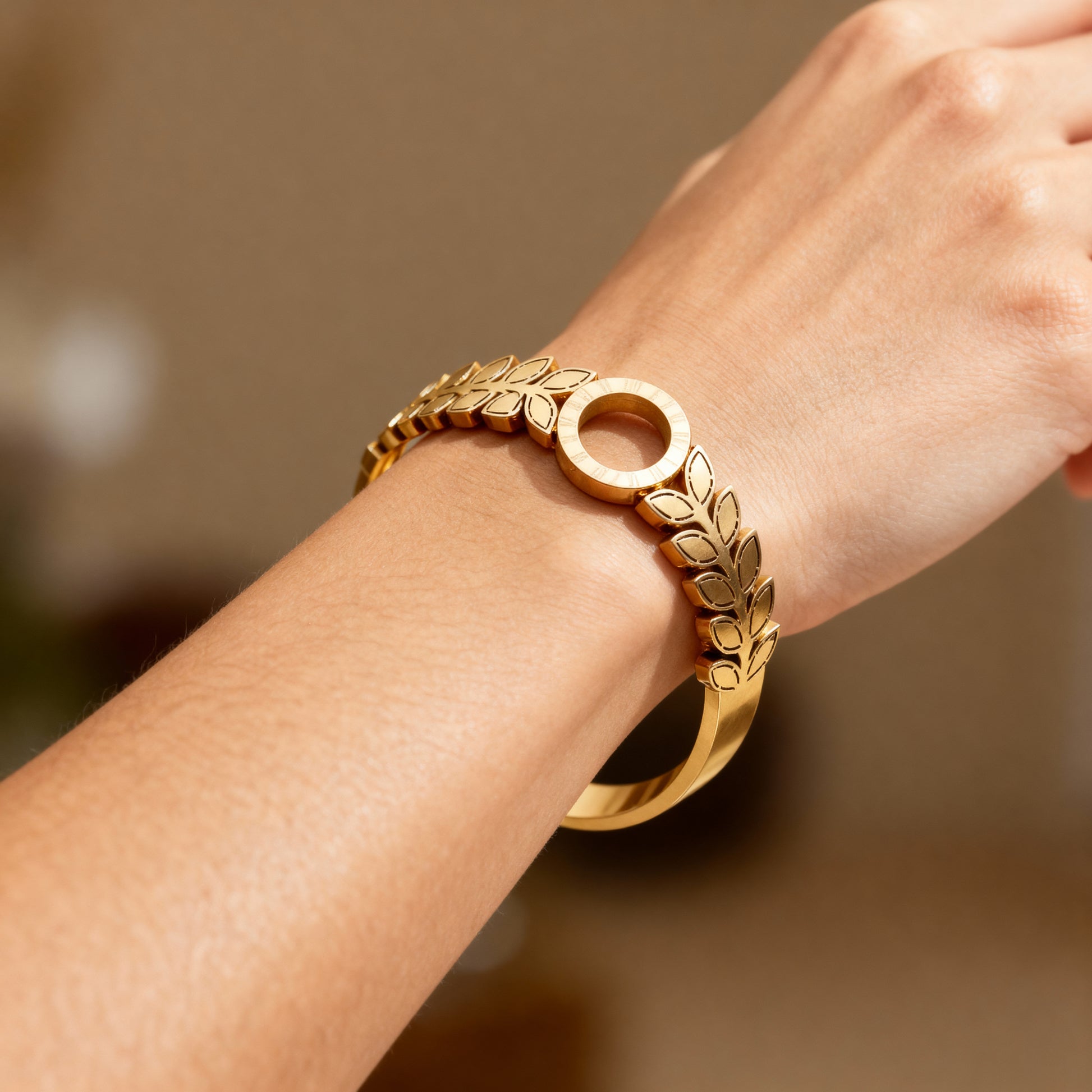 Modern Gold Finish Leaf Pattern Bangle with Circular Centerpiece